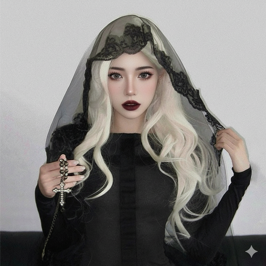 Person with long blonde hair wearing a black veil with lace details against a plain background