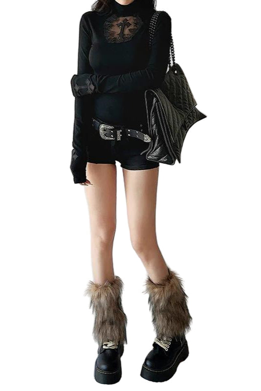 Person wearing a black outfit with fur-trimmed boots on a plain background