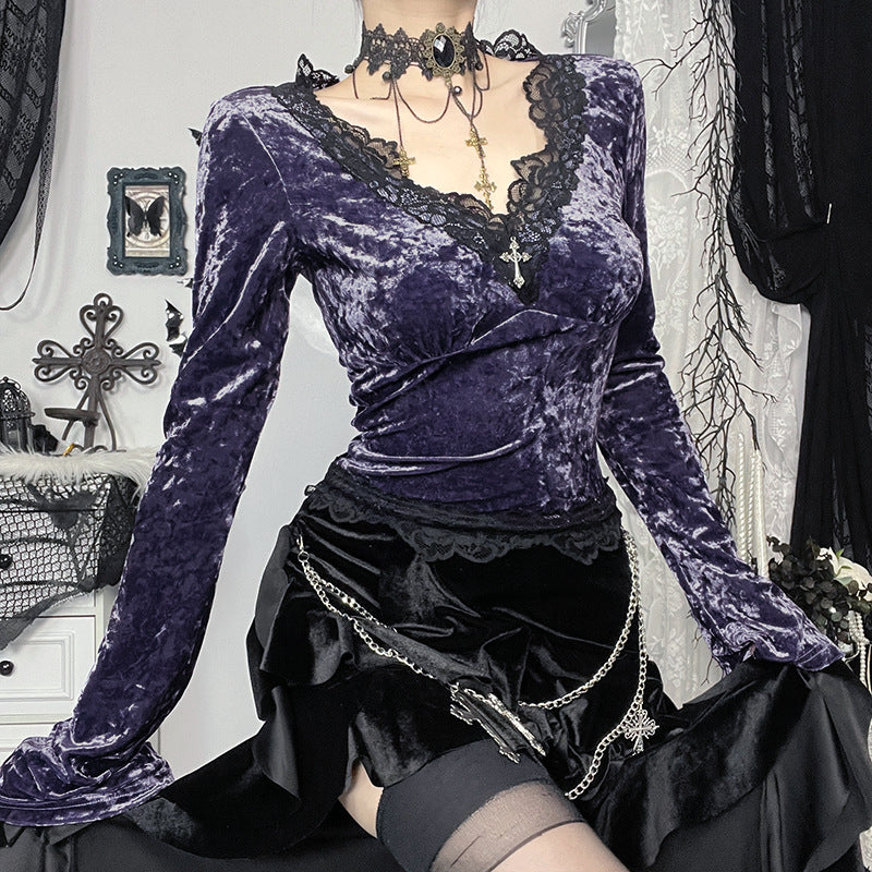 Purple velvet top with long sleeves and black skirt on a white background