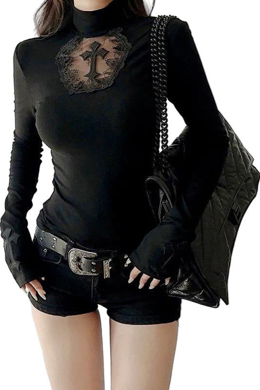 Person wearing a black long-sleeve top with lace detail and black shorts, holding a black jacket.