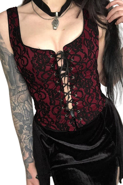 Person wearing a red lace corset with black satin skirt against a white background
