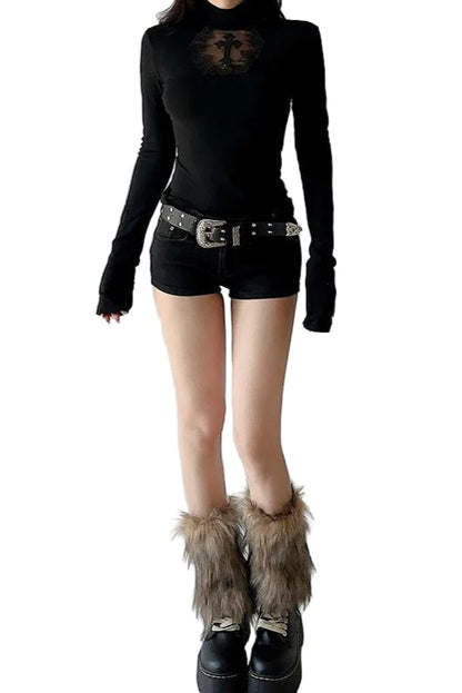 Person wearing a black outfit with fur-trimmed boots on a plain background