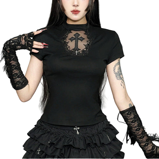 Person wearing a black outfit with lace details in a decorative setting.