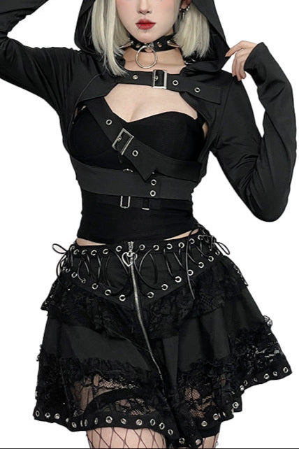 Person wearing a black gothic outfit with a hood on a white background