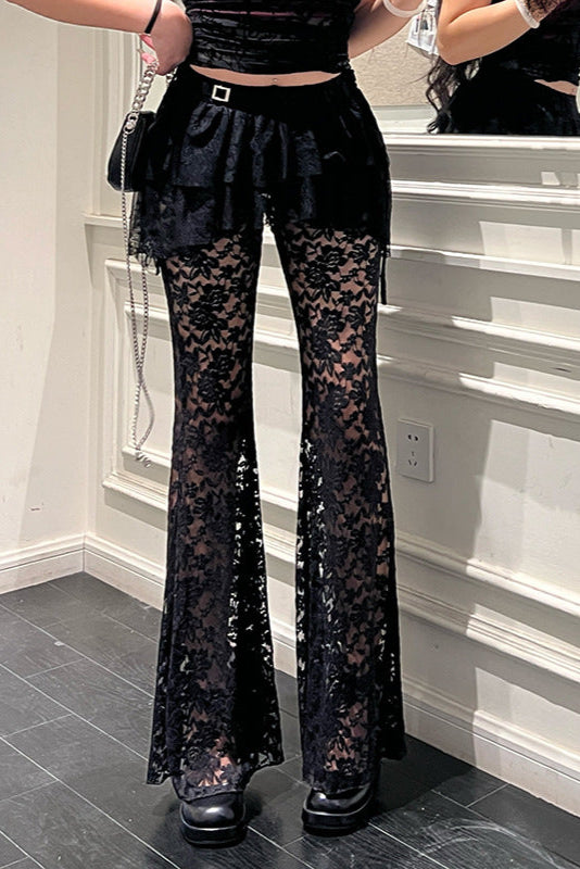 Person wearing black lace pants in a room with a mirror.