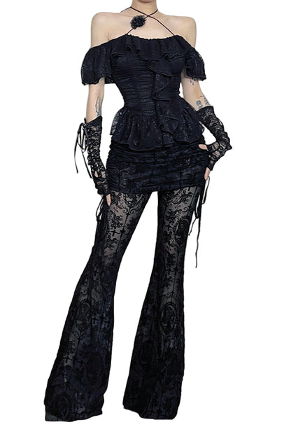 Person wearing a black lace outfit in a Halloween-themed room with decorations.