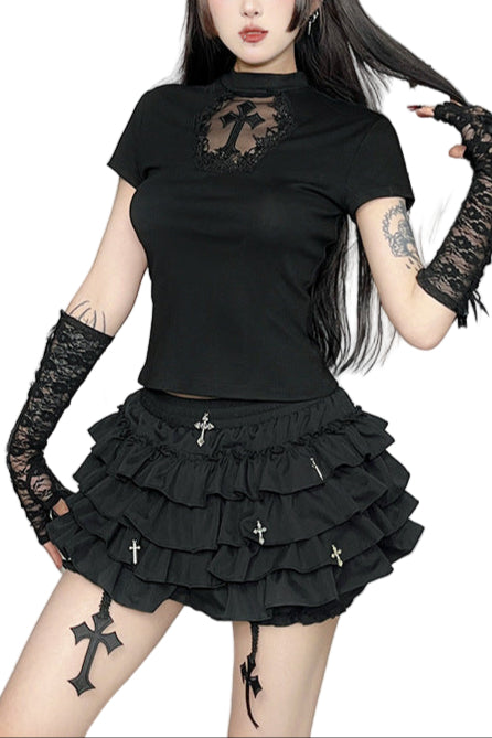 Gothic-style outfit with black top and skirt in a decorative room.