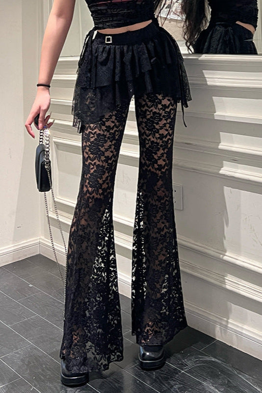 Person wearing black lace pants in a room with a mirror.
