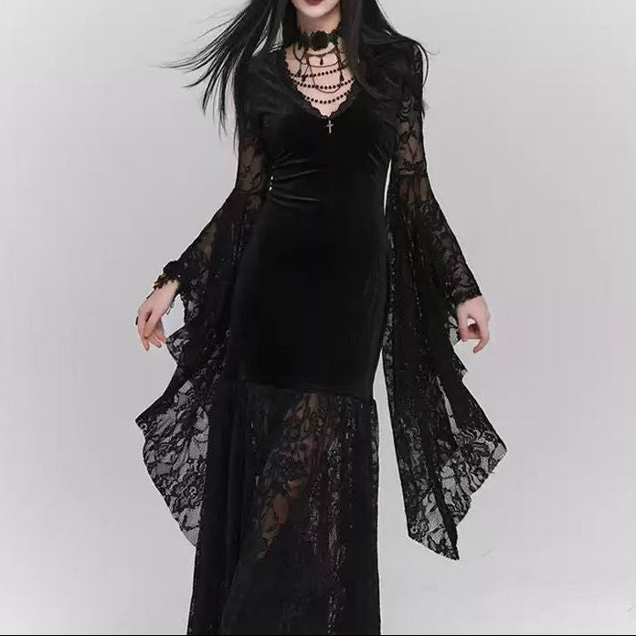 Woman wearing a black lace dress with sheer sleeves on a white background