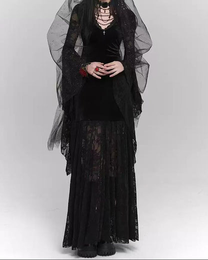Person wearing a black gothic outfit with a sheer black veil on a white background