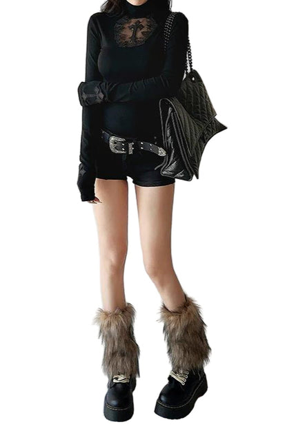 Person wearing a black outfit with fur-trimmed boots on a plain background