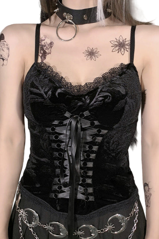 Person wearing a black lace corset with chains in an indoor setting