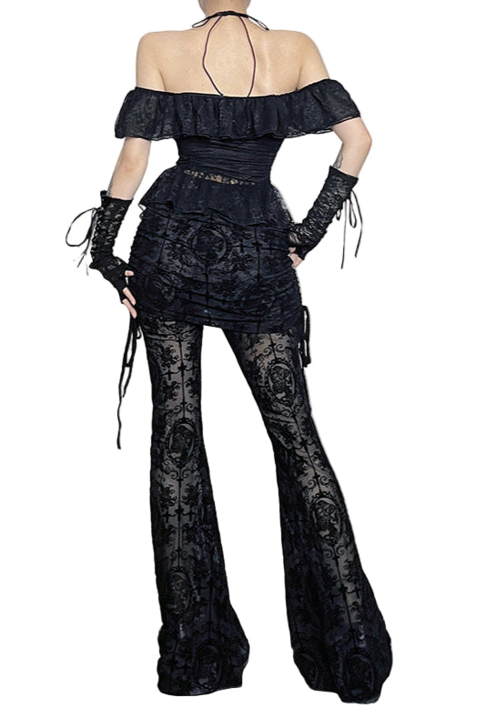Person wearing a black lace outfit in a Halloween-themed room with pumpkins and decorations.