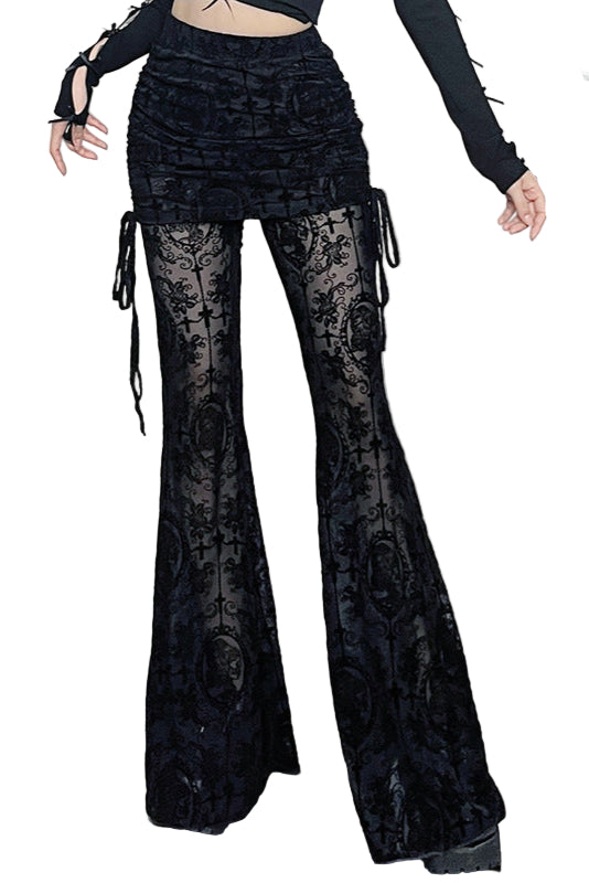 Person wearing black lace pants in a room with decorative elements.