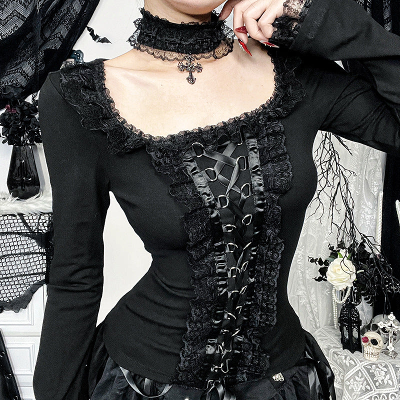Person wearing a black Victorian-style dress with intricate details and lace
