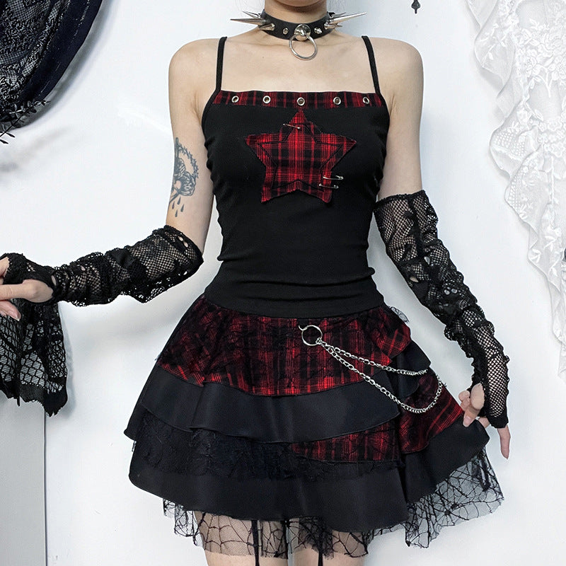 Person wearing a black and red plaid outfit with lace sleeves and skirt.