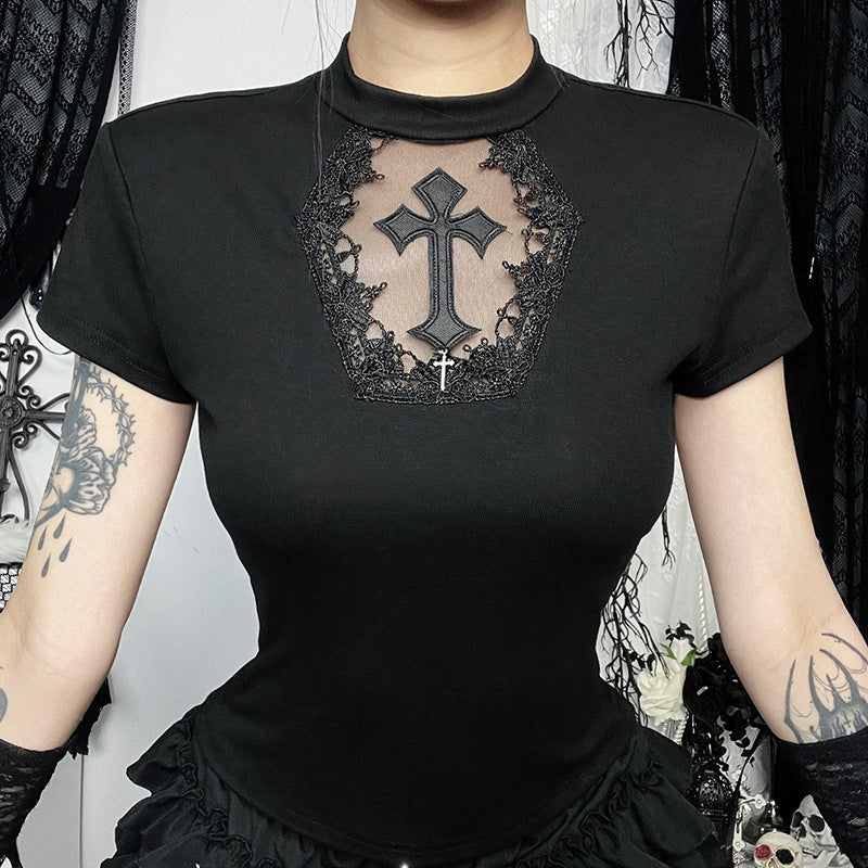 Black t-shirt with a cross design on a person against a decorative background