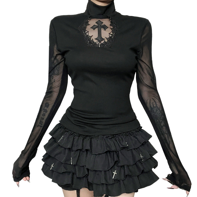 Black long-sleeve top with sheer sleeves and a black skirt on a white background
