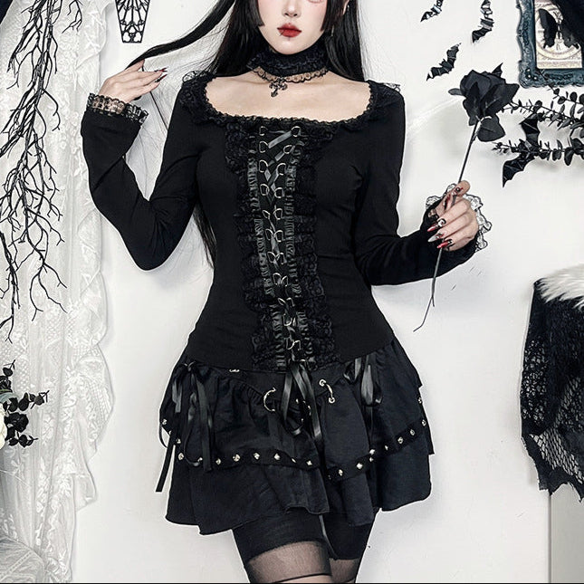 Person wearing a black gothic outfit with decorative elements against a white background.