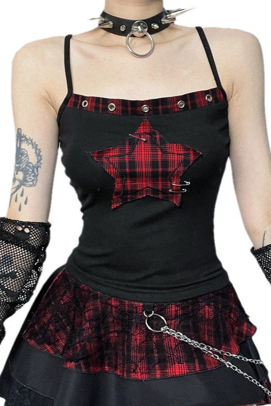 Person wearing a black and red plaid top with star design and matching skirt on a white background