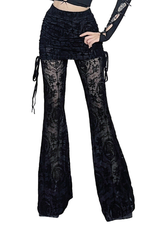 Person wearing black lace pants in a decorative room with skulls and candles.