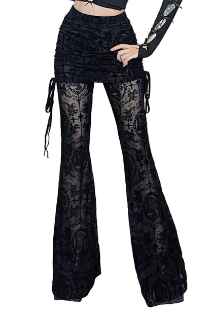 Person wearing black lace pants in a decorative room with skulls and candles.