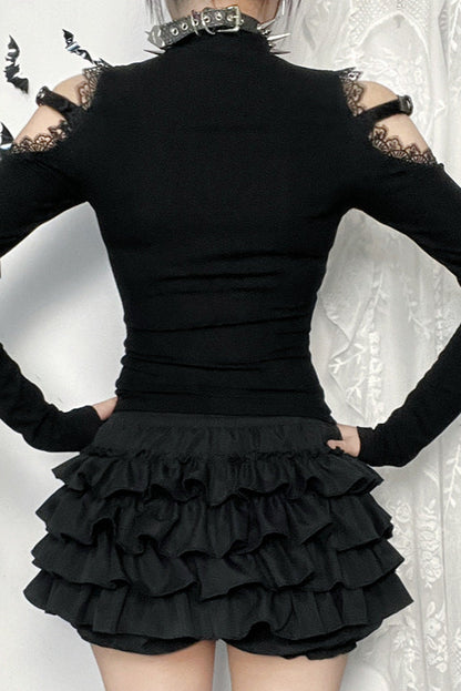 Black outfit with ruffled skirt and lace sleeves on a white background