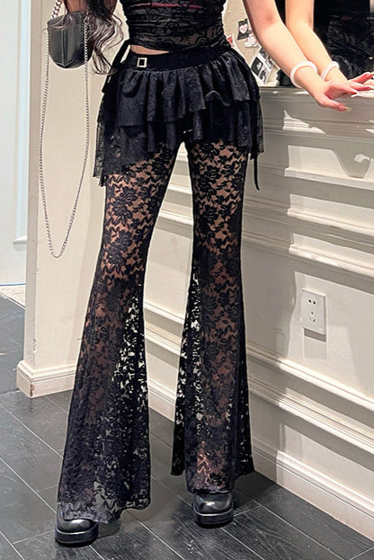 Person wearing black lace pants in a room with gray flooring and white walls.