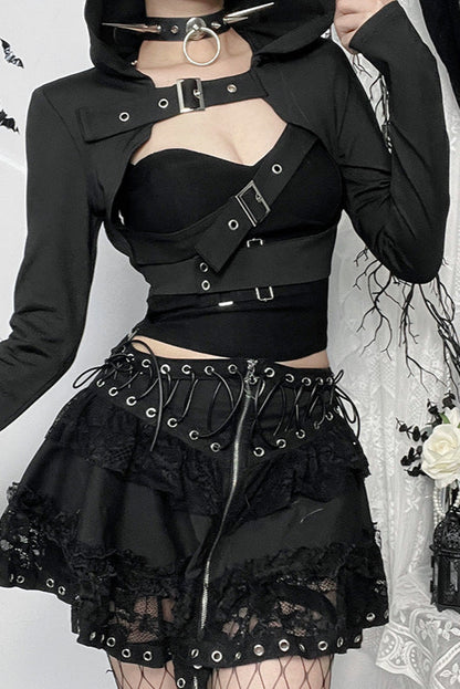 Person wearing a black gothic outfit with lace details against a decorative background.
