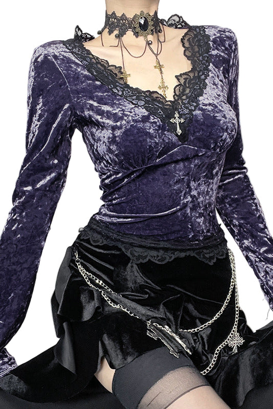 Purple velvet top with long sleeves and black skirt on a white background