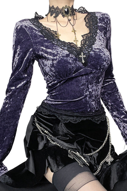 Purple velvet top with long sleeves and black skirt on a white background