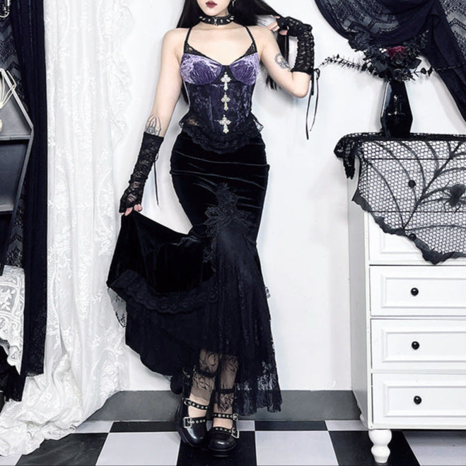 Woman in a gothic-style outfit standing in a decorated room with black and white decor.