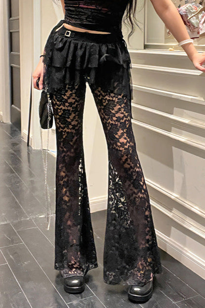 Person wearing black lace flared pants in a room with a staircase.