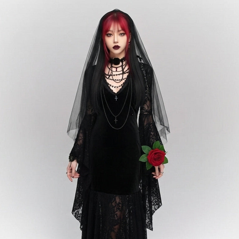 Person wearing a black dress with a sheer overlay and holding a red flower against a white background